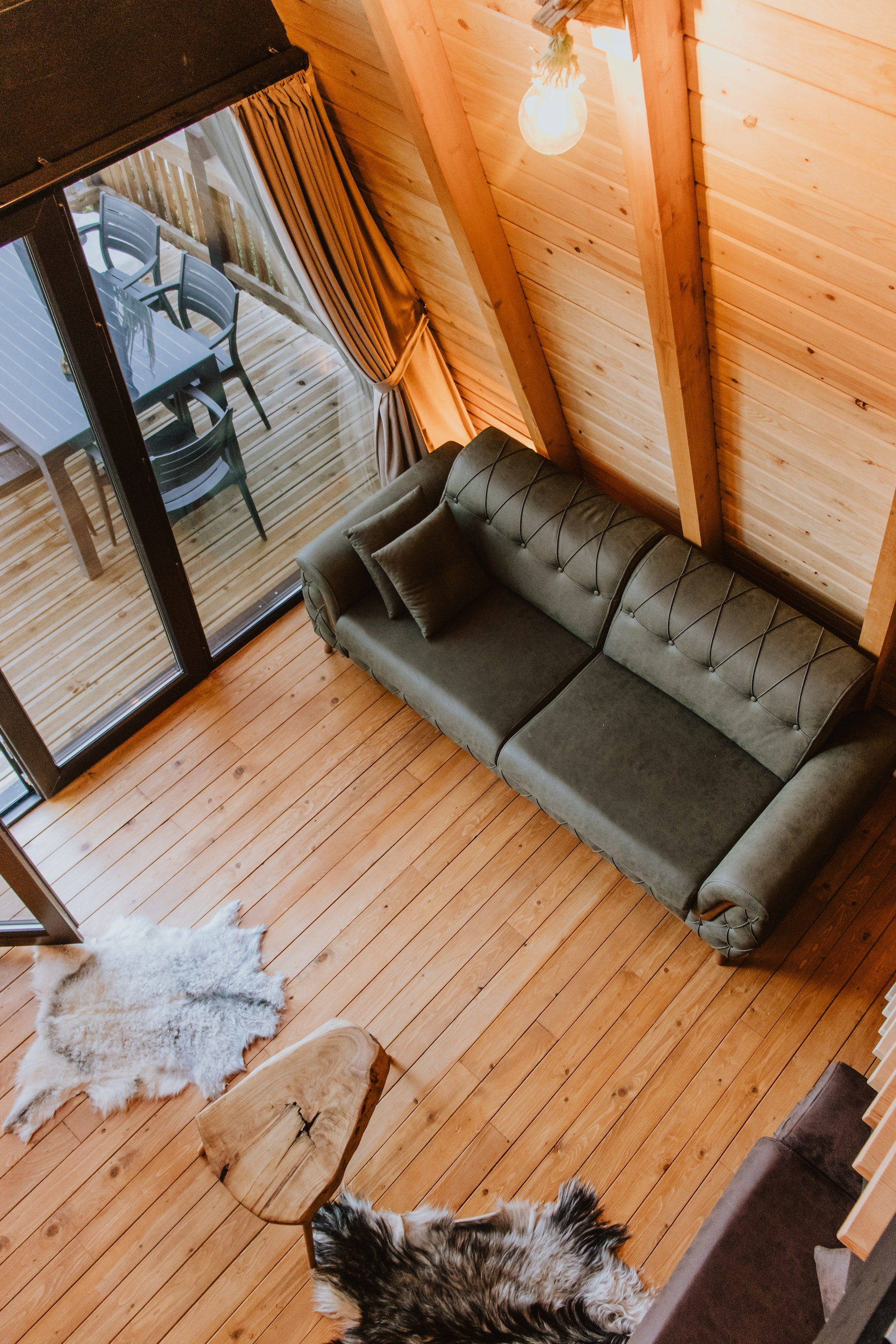 green love seat in log cabin